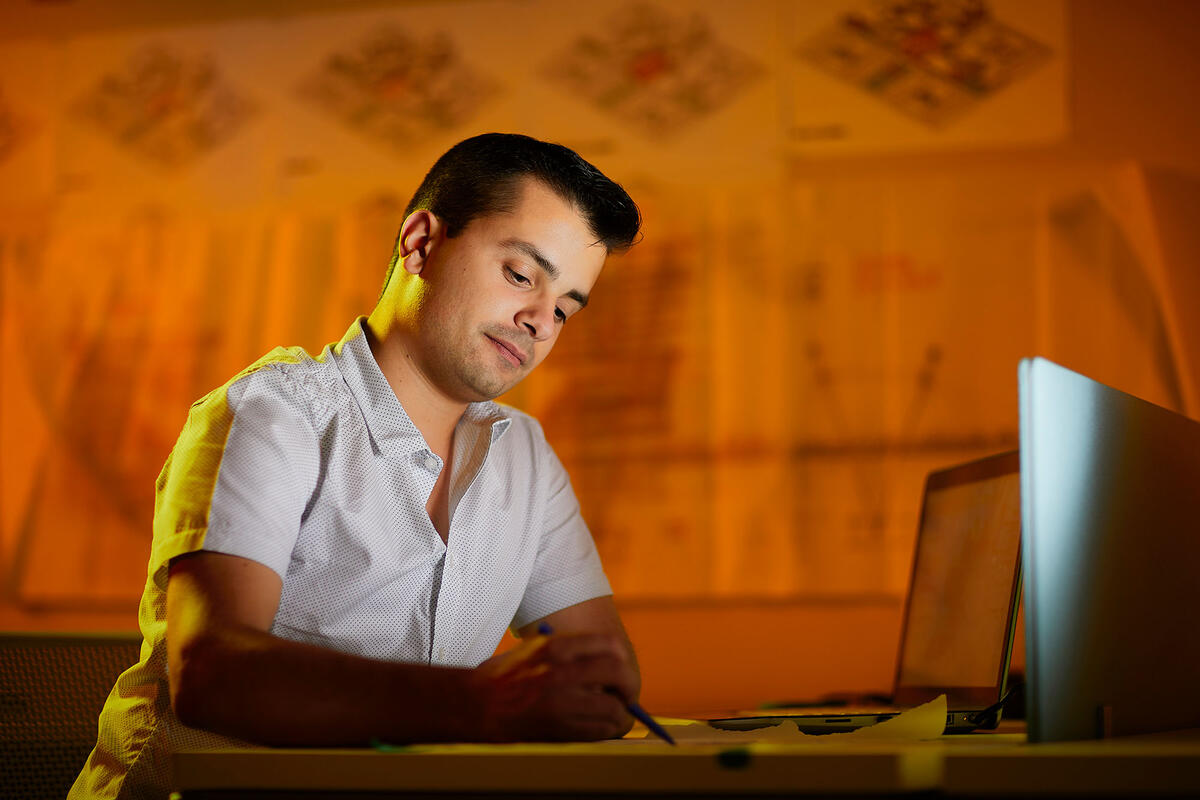 Rafael Antonio Armendariz working at his computer.