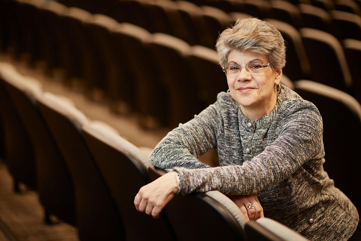 Marla Stafford seated in a row of chairs.