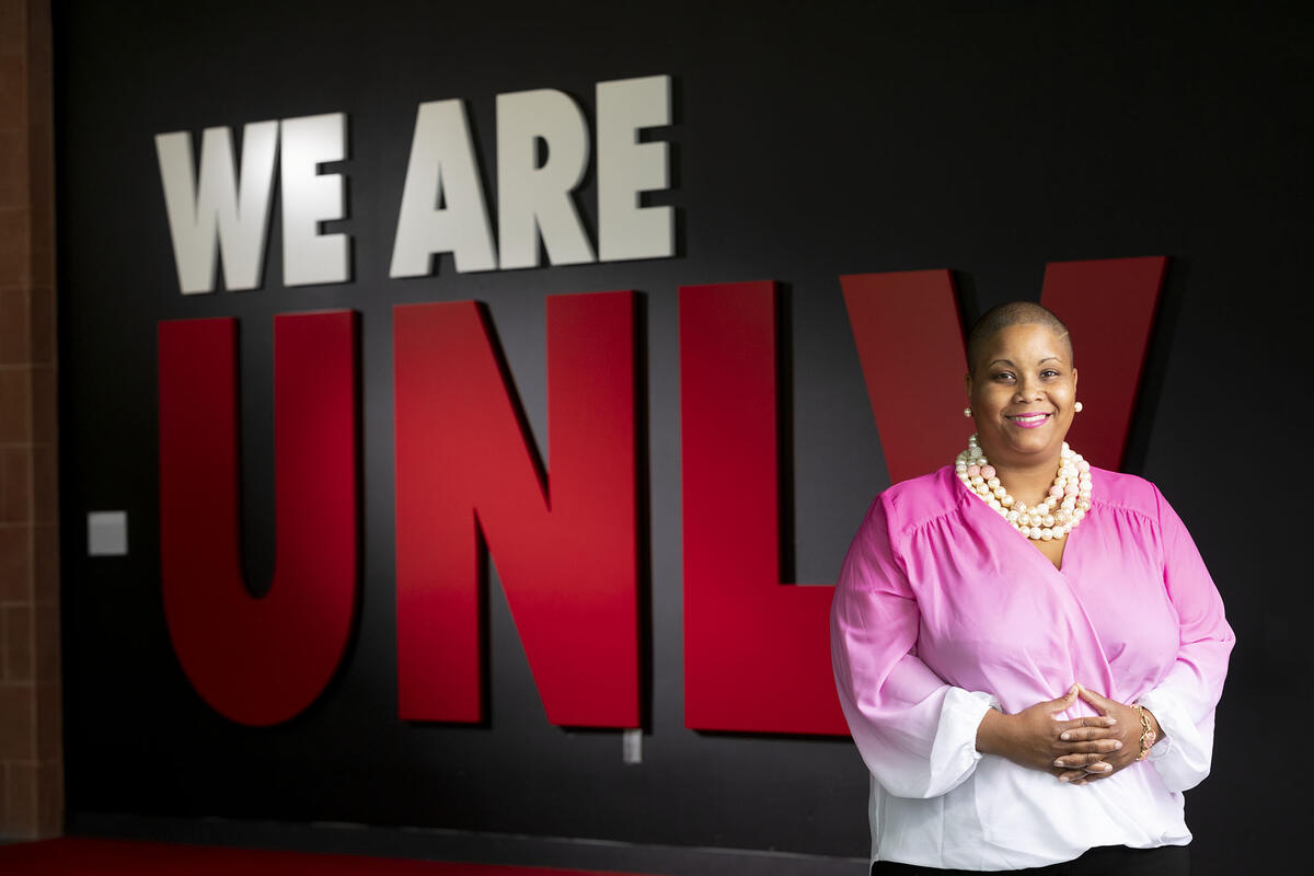 Renee Watson stands in front of "We Are UNLV" sign.