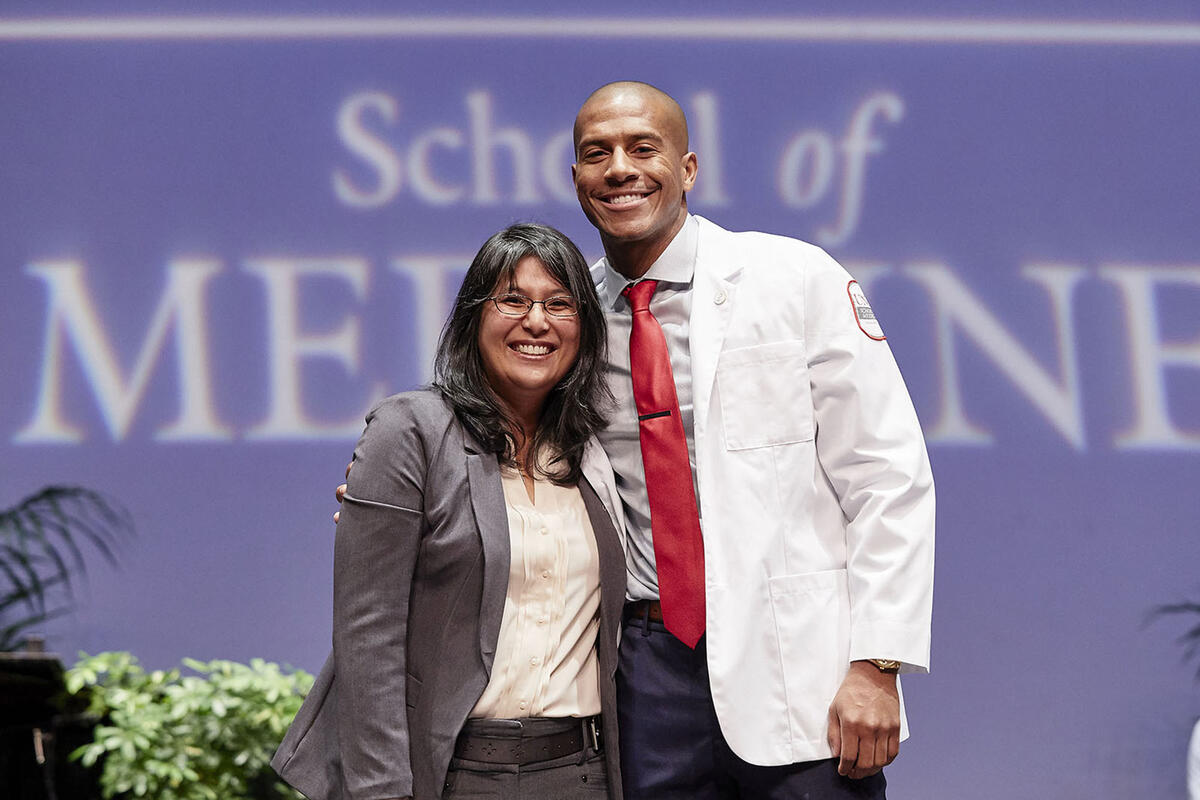 a woman and man wearing a doctor's coat
