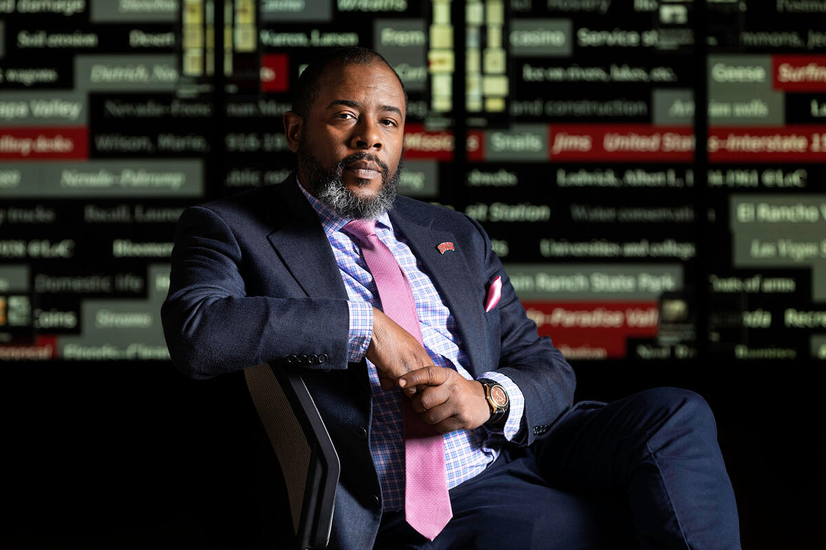 Darnelle Melvin in front of displays of metadata.