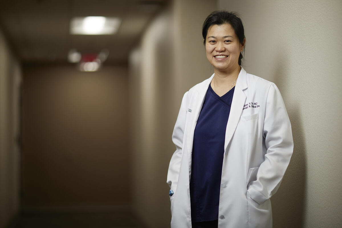 woman in doctor's coat in hallway