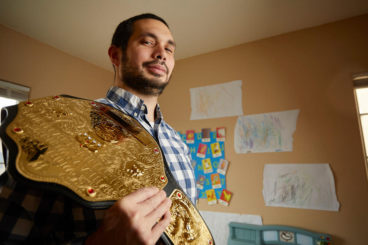 Michael Chin with his replica wrestling championship belt.