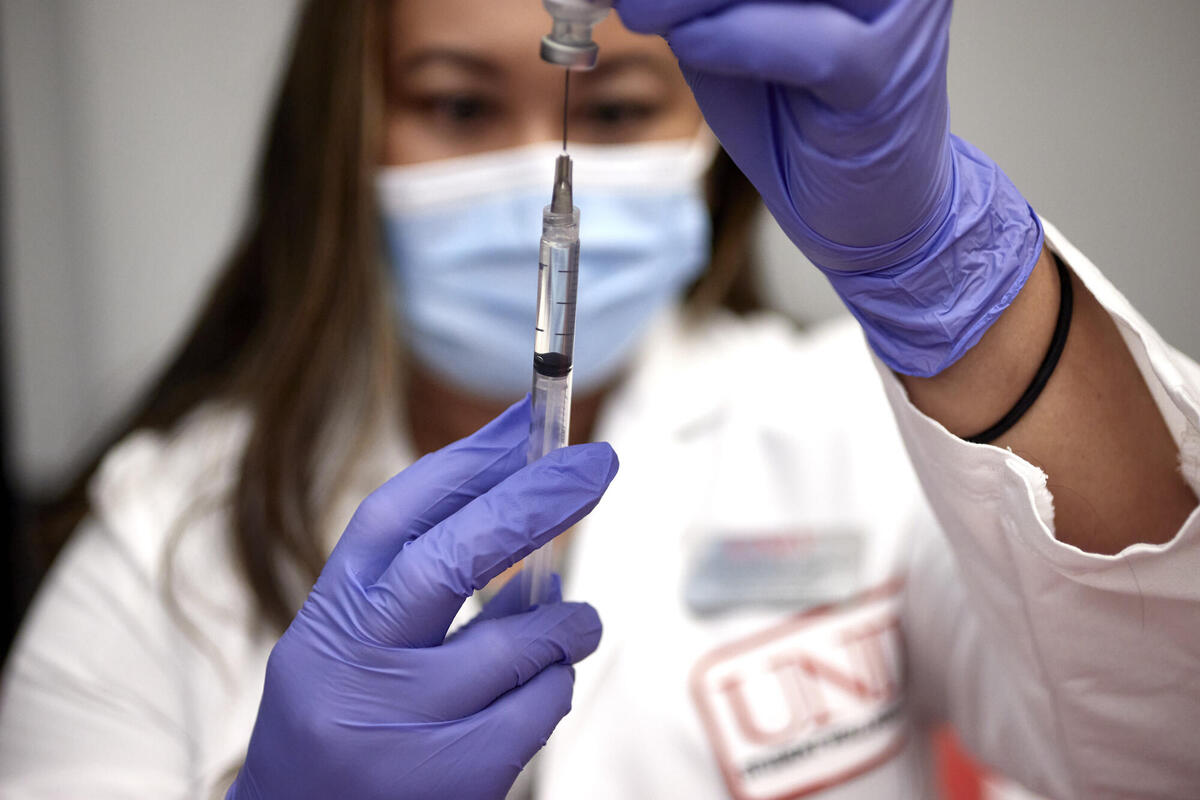 healthcare worker filling syringe
