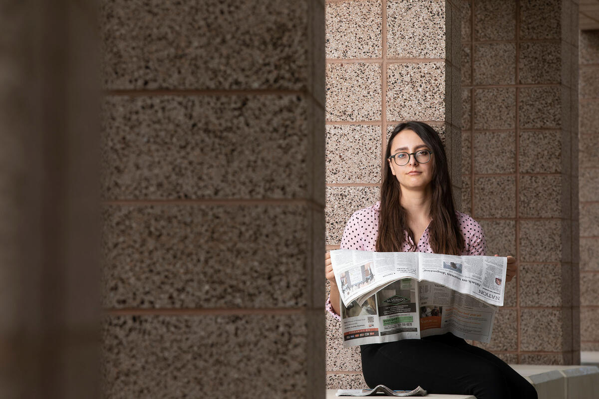 woman holding newspaper