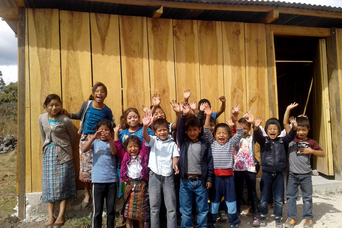 group of children in front of wooden structure
