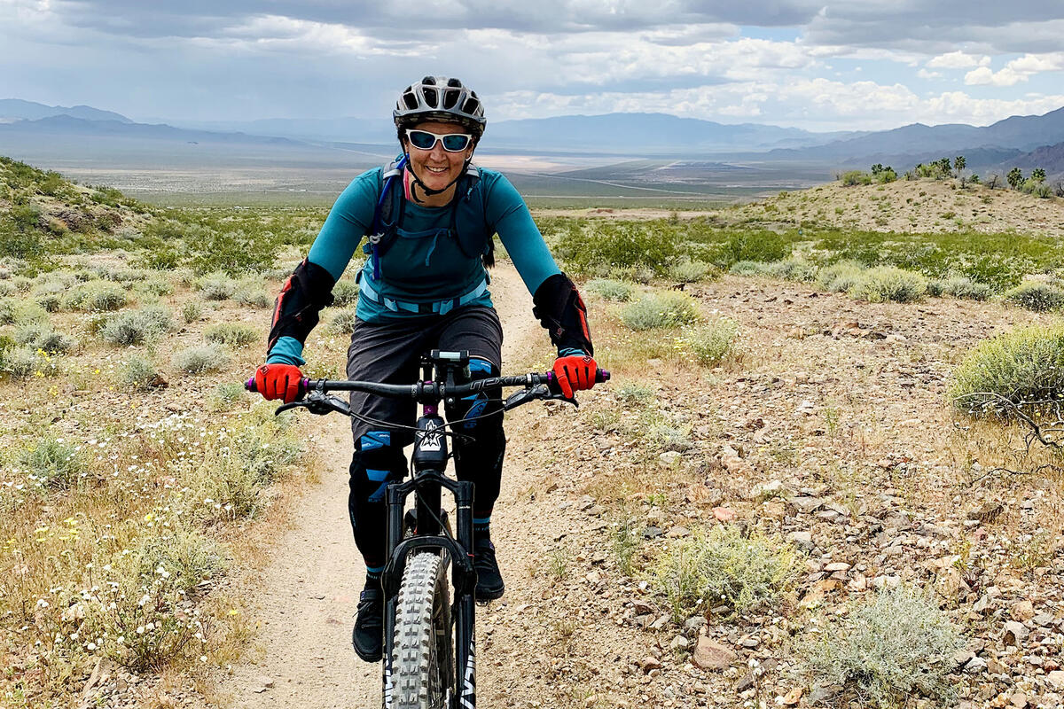 Summer Mudd riding a mountain bike in the desert