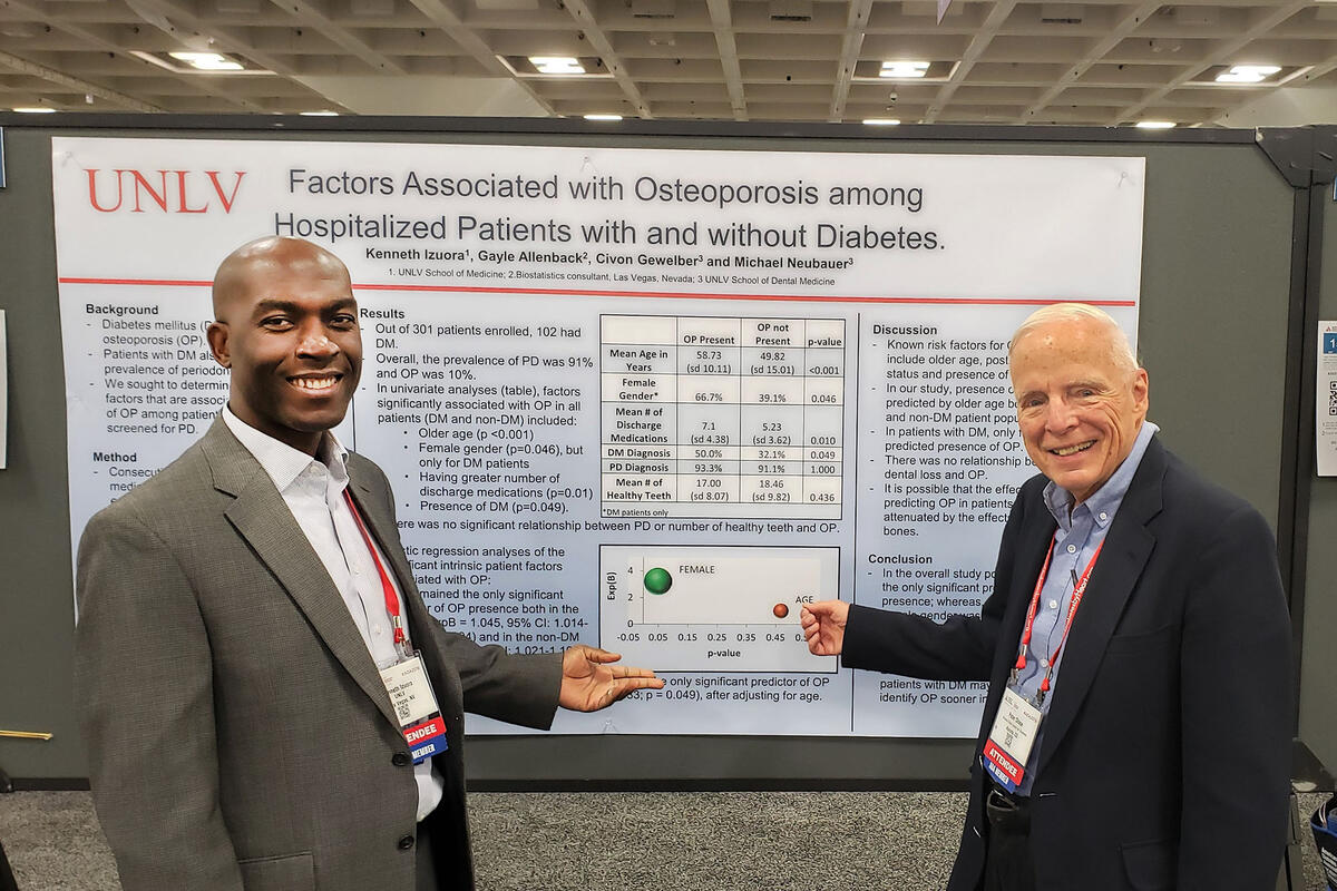 two men in front of research poster