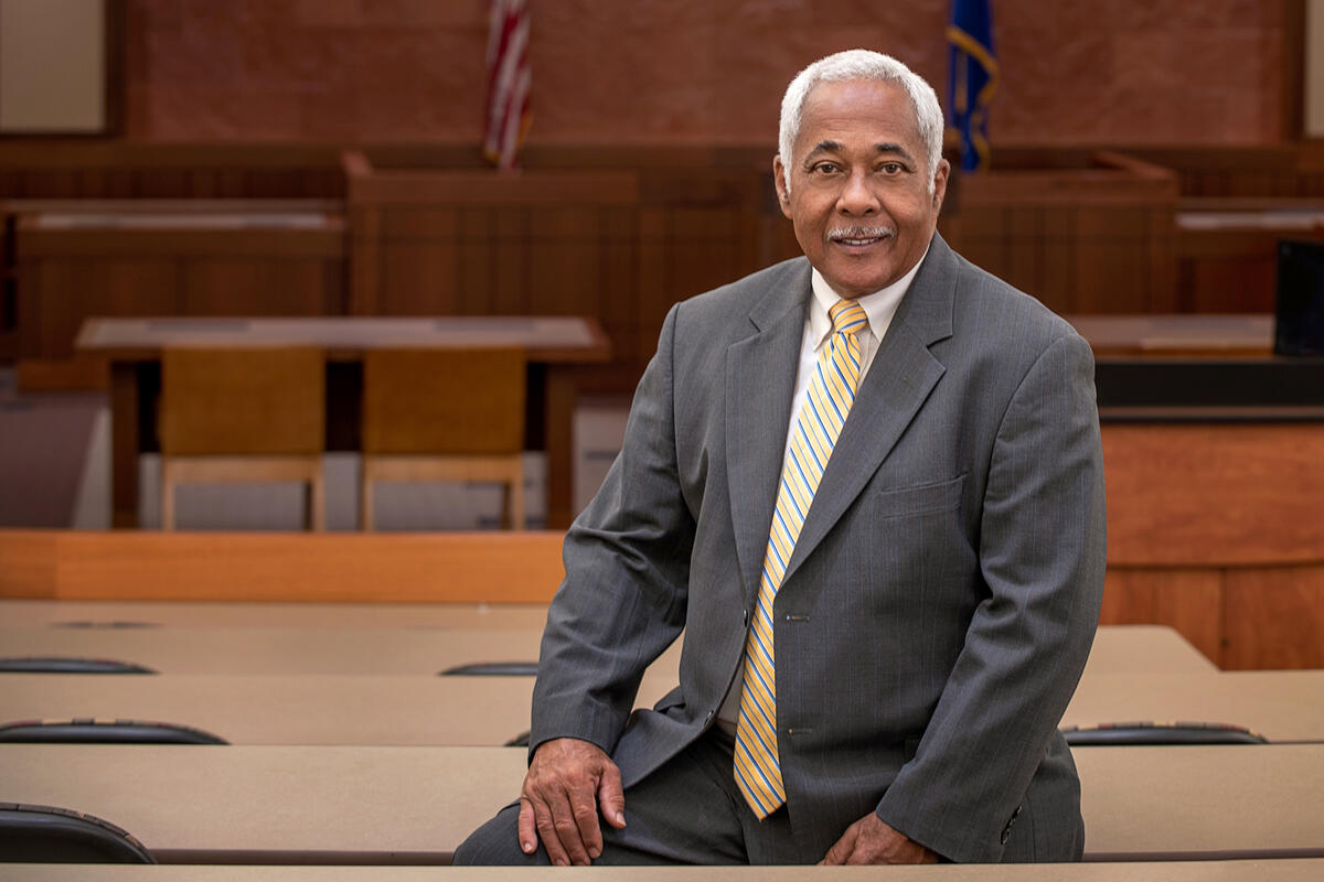 Justice Douglas seated in a classroom