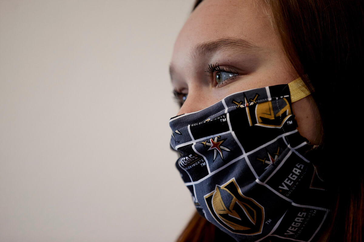 A woman wears a cloth face mask