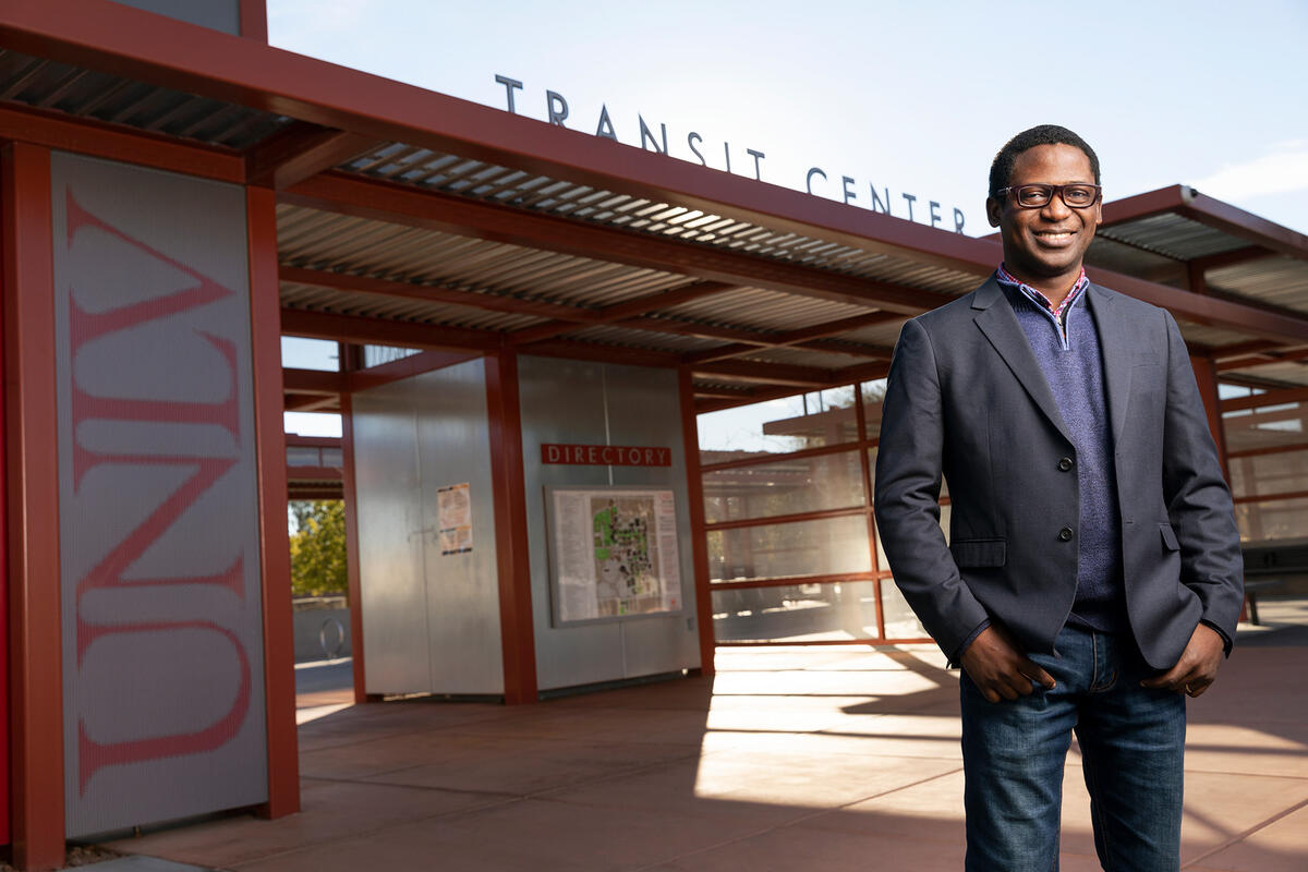 Student John Olawepo stands in front of the UNLV bus station.