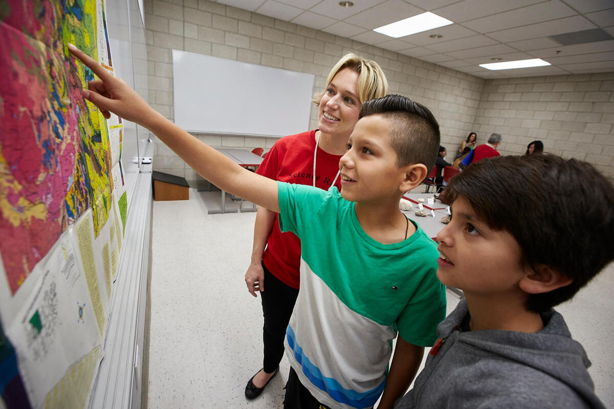 Students point at artwork