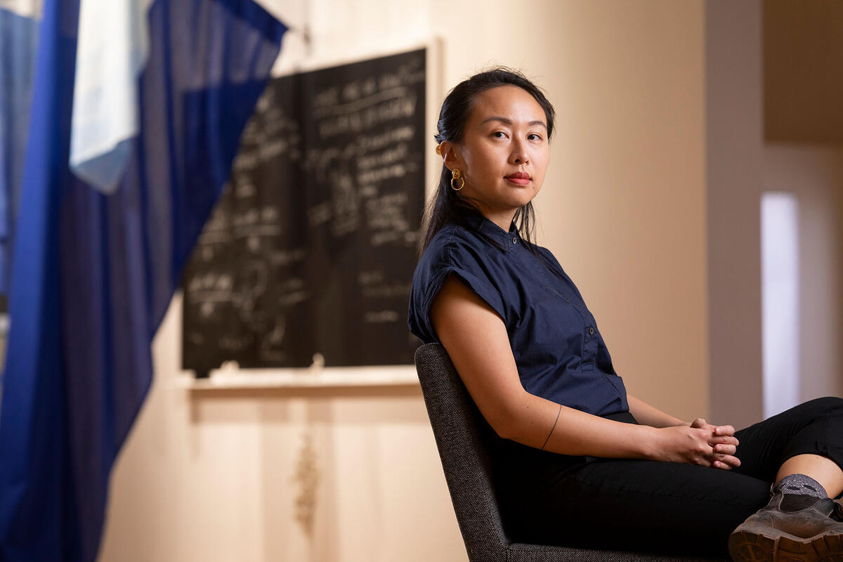 woman seated in front of art exhibition