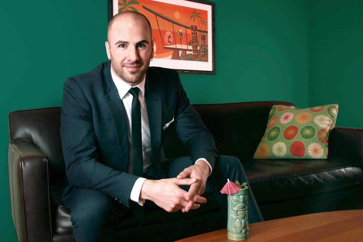 A man in a suit sitting down on a couch