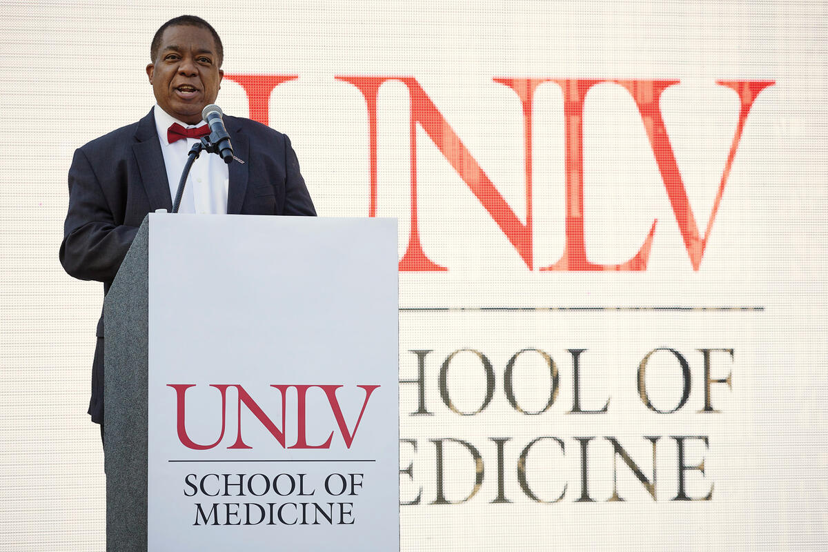 A man stands at a UNLV School of Medicine podium