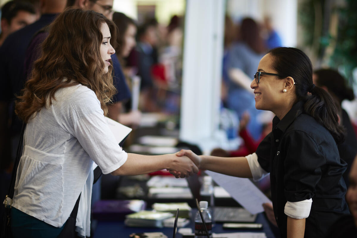 two women shaking hands