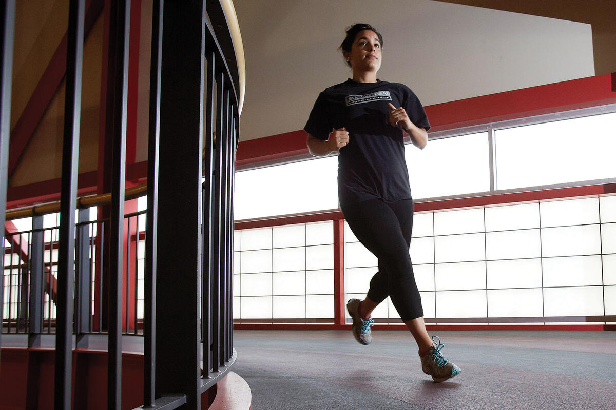 woman jogging on indoor track
