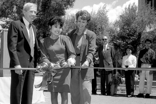 Valerie Pida cutting the ribbon for the dedication of the plaza