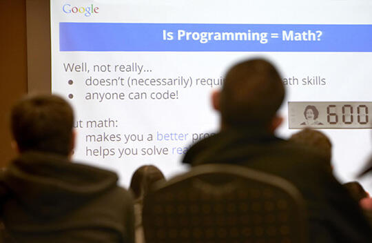 Students watch a presentation about programming