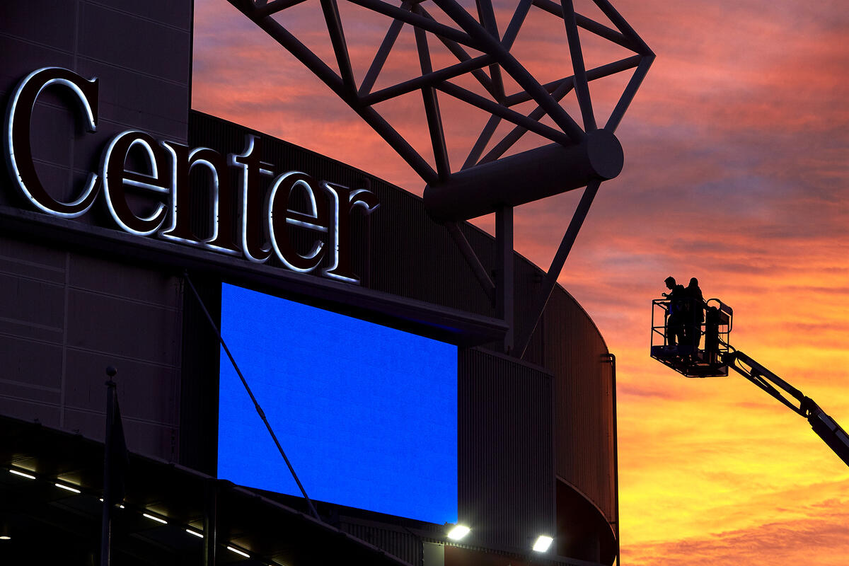 Signage being hung on the Thomas and Mack Center