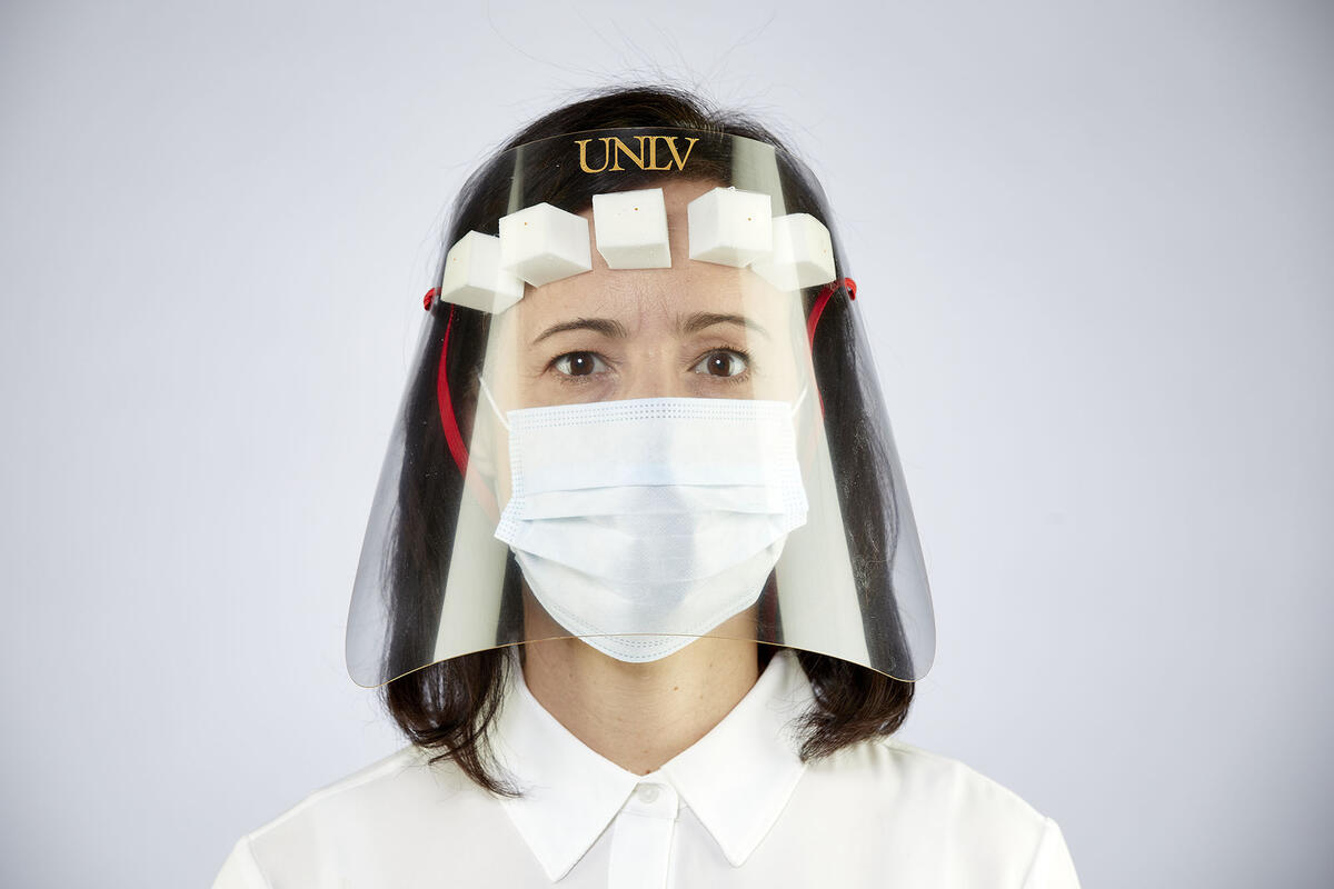 woman wearing face shield and face mask
