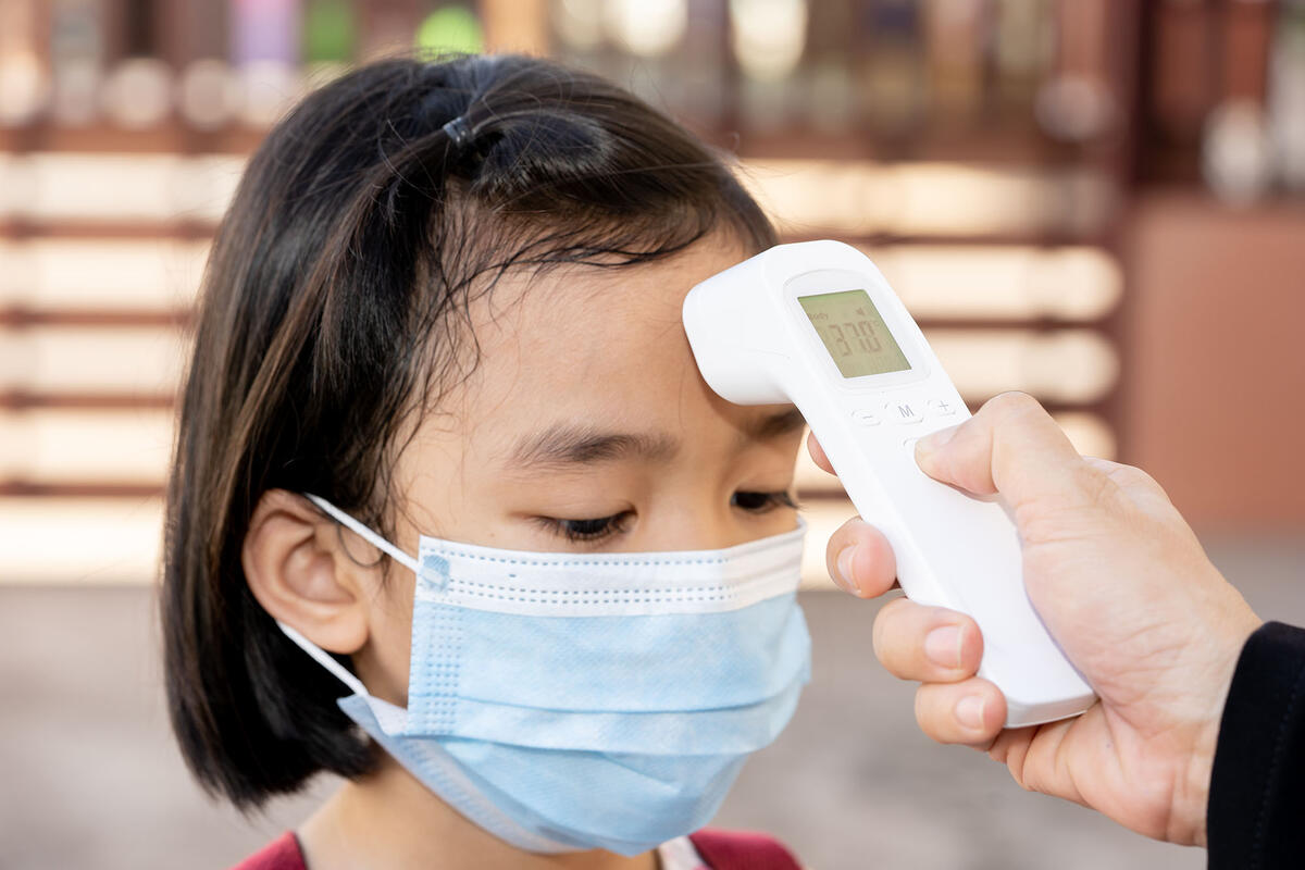 Child getting temperature taken