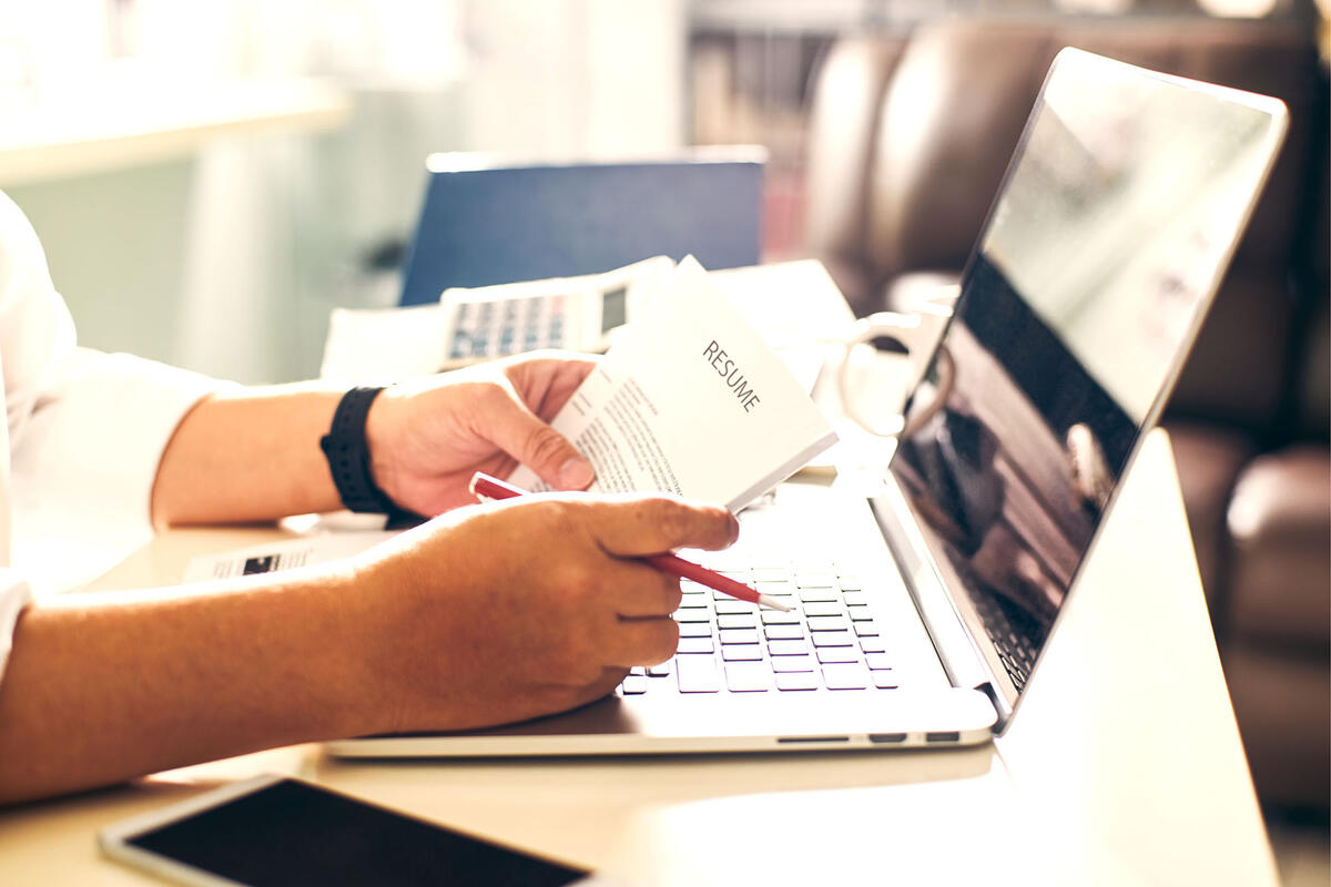closeup of person holding resume