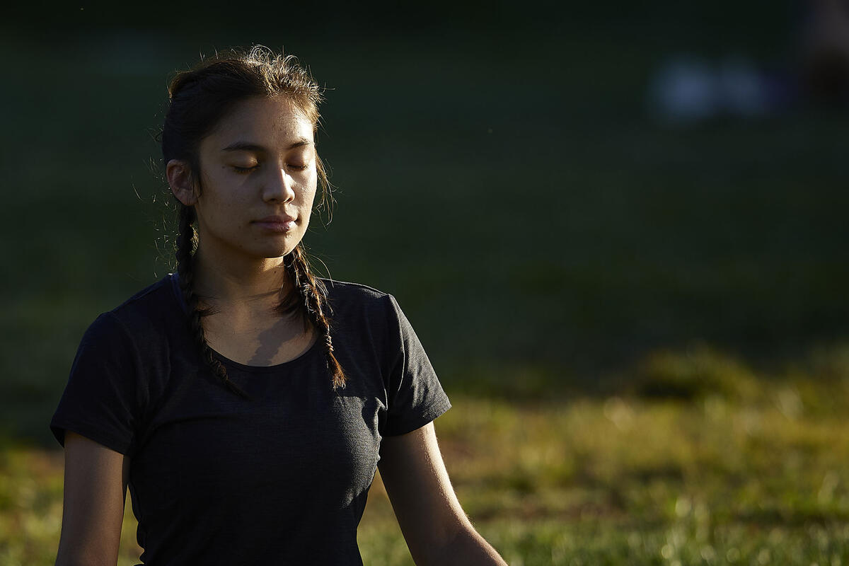 woman sitting outside with eyes closed