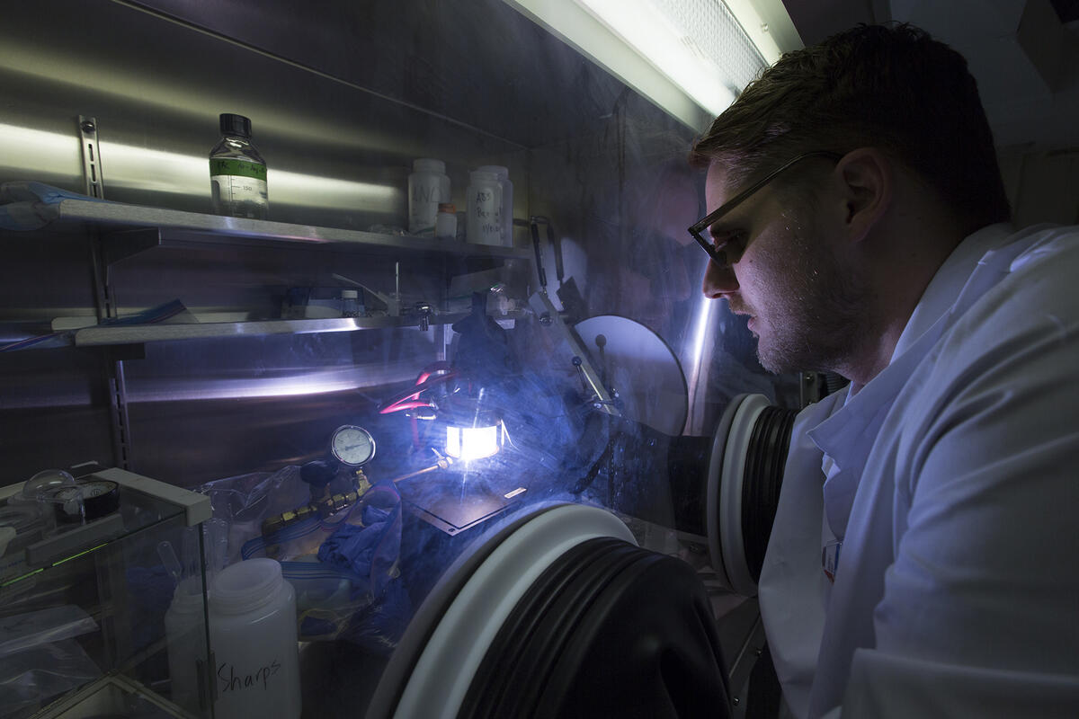 Chemist looks through a laser