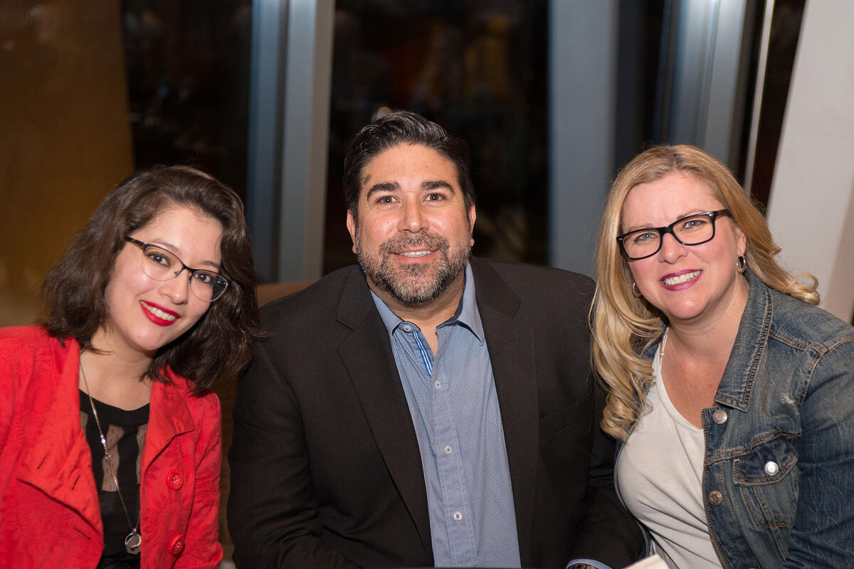 Three people smiling