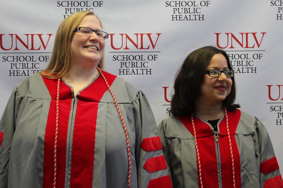 Two graduates smiling