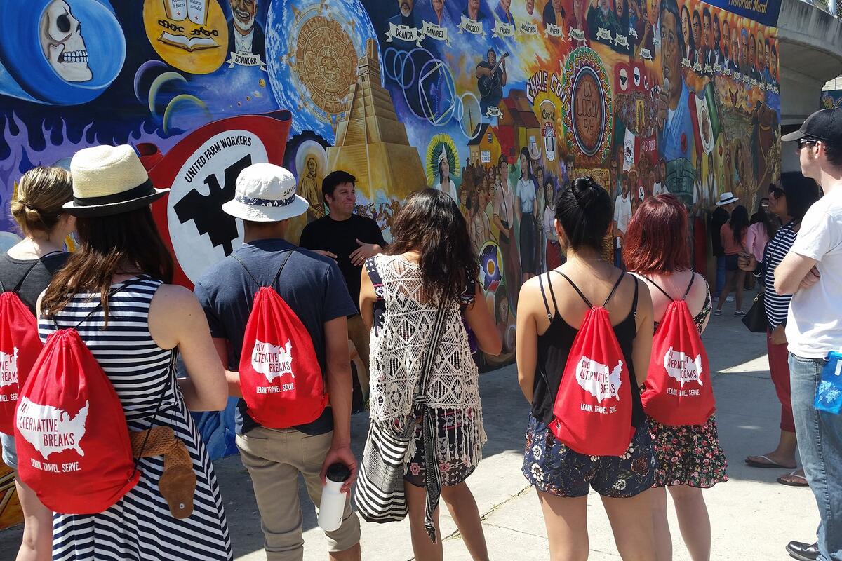 A group of people looking at a mural