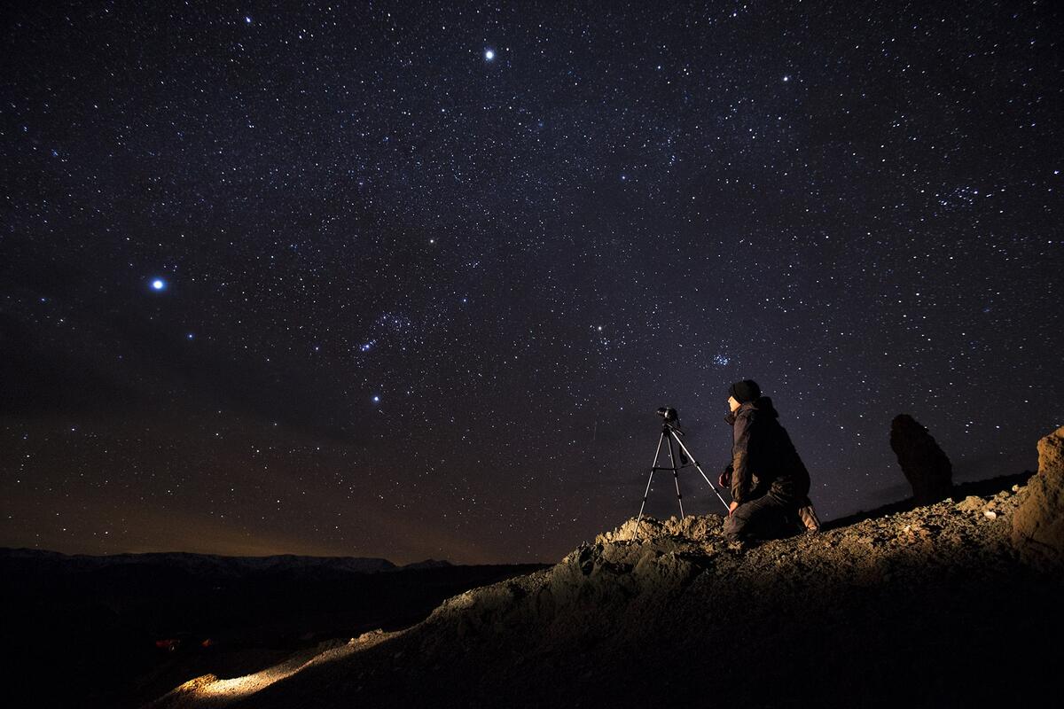 Student photographing night sky