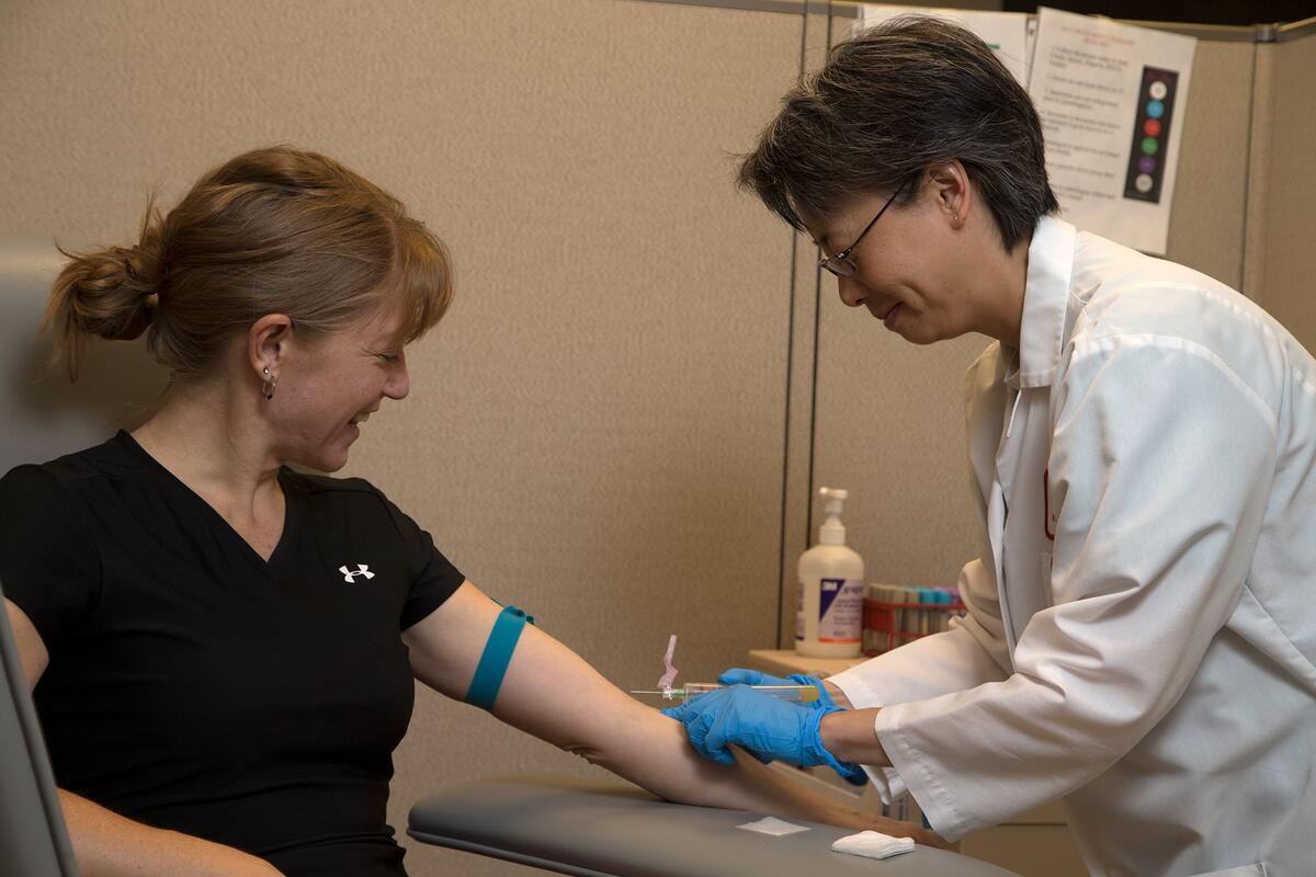 A patient at an appointment giving blood for labs.
