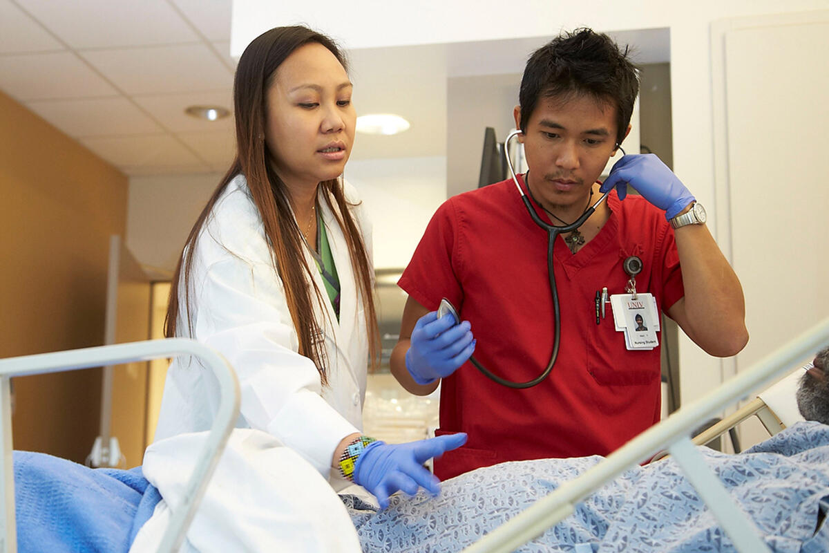 Student nurse working with a mentor at the hospital