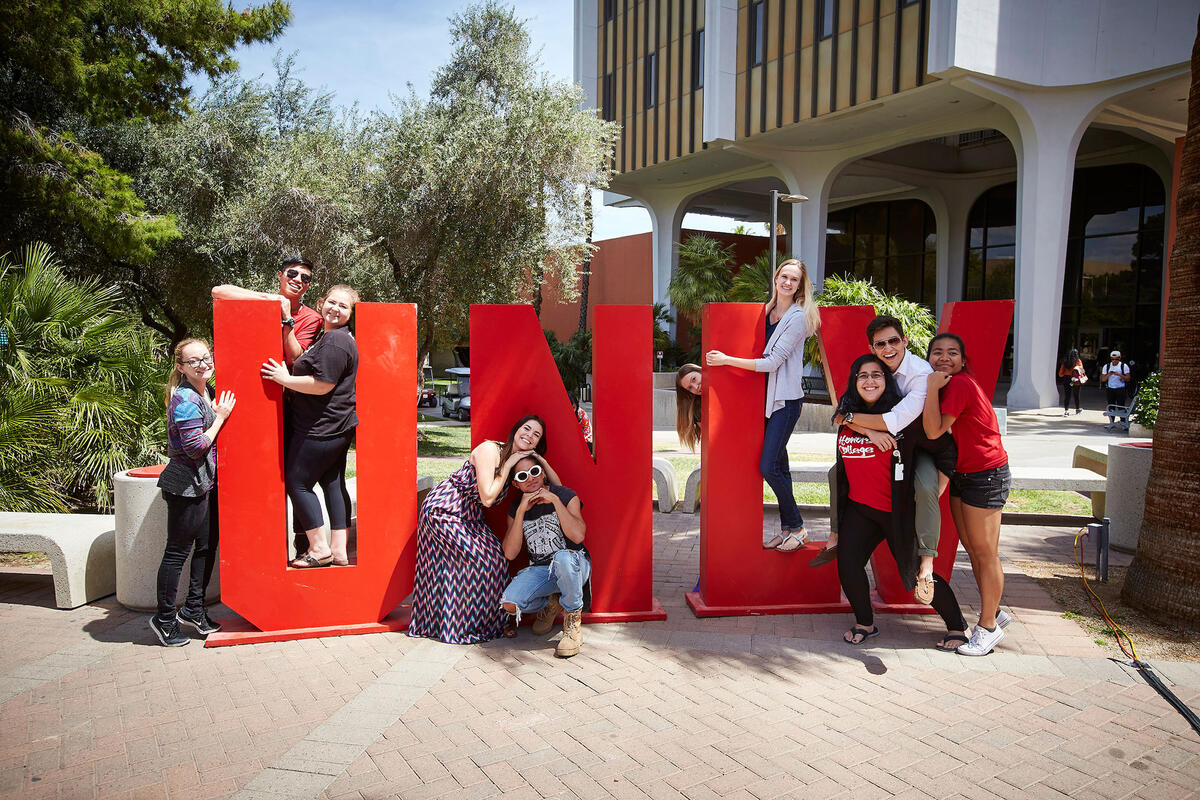 Students pose around giant U-N-L-V letters