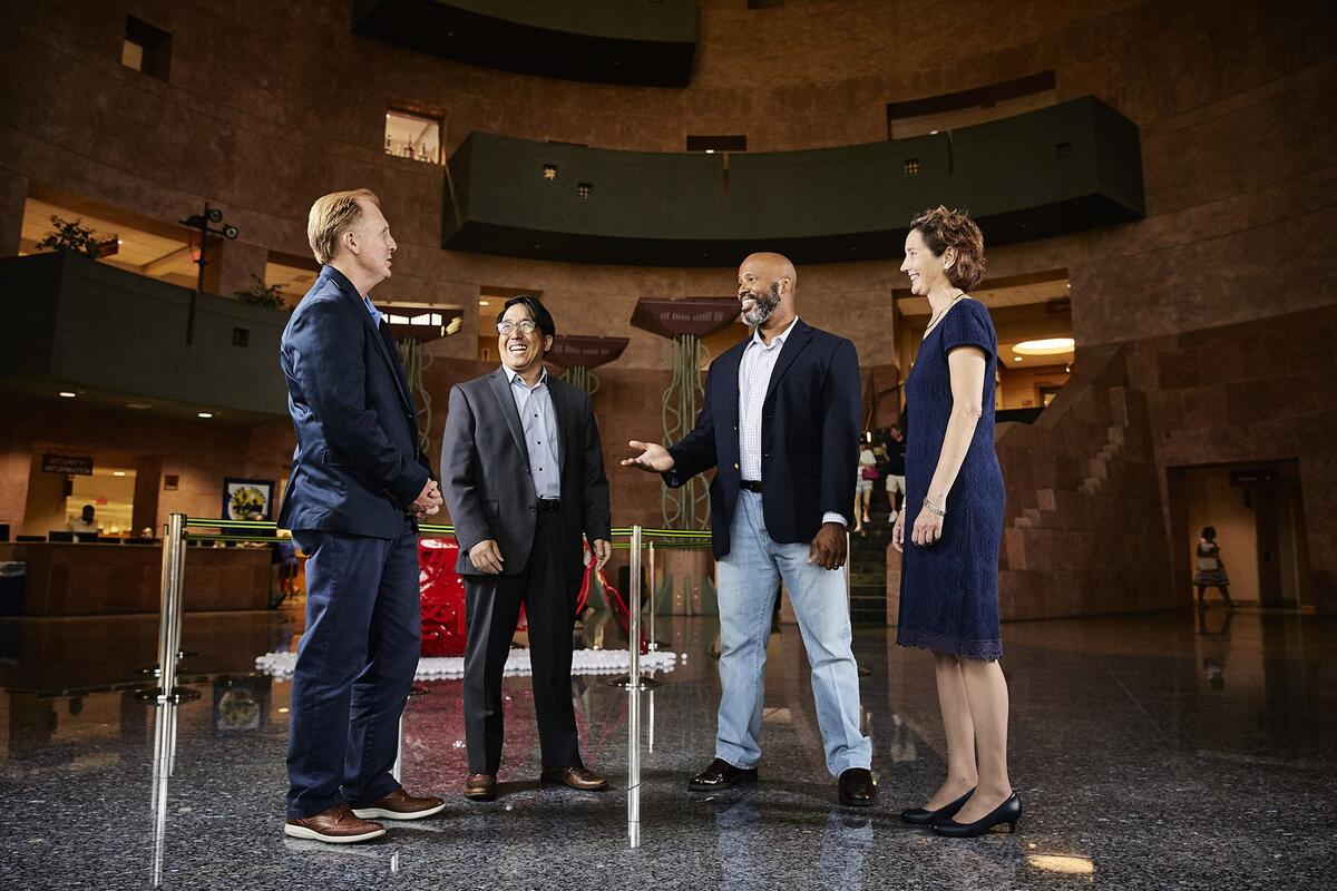 Four people having a meeting in a building.