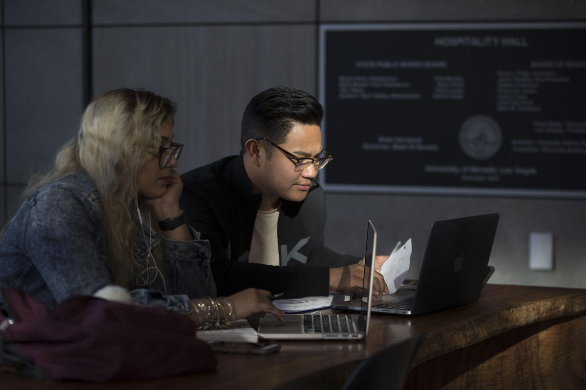 Two students working on their computers.