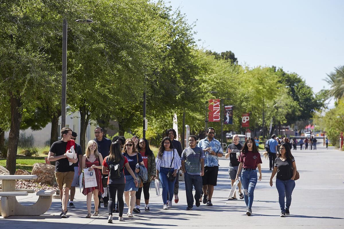 Group of people walking through campus