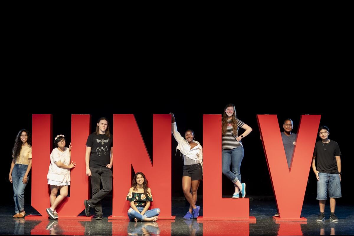Students standing with UNLV letters