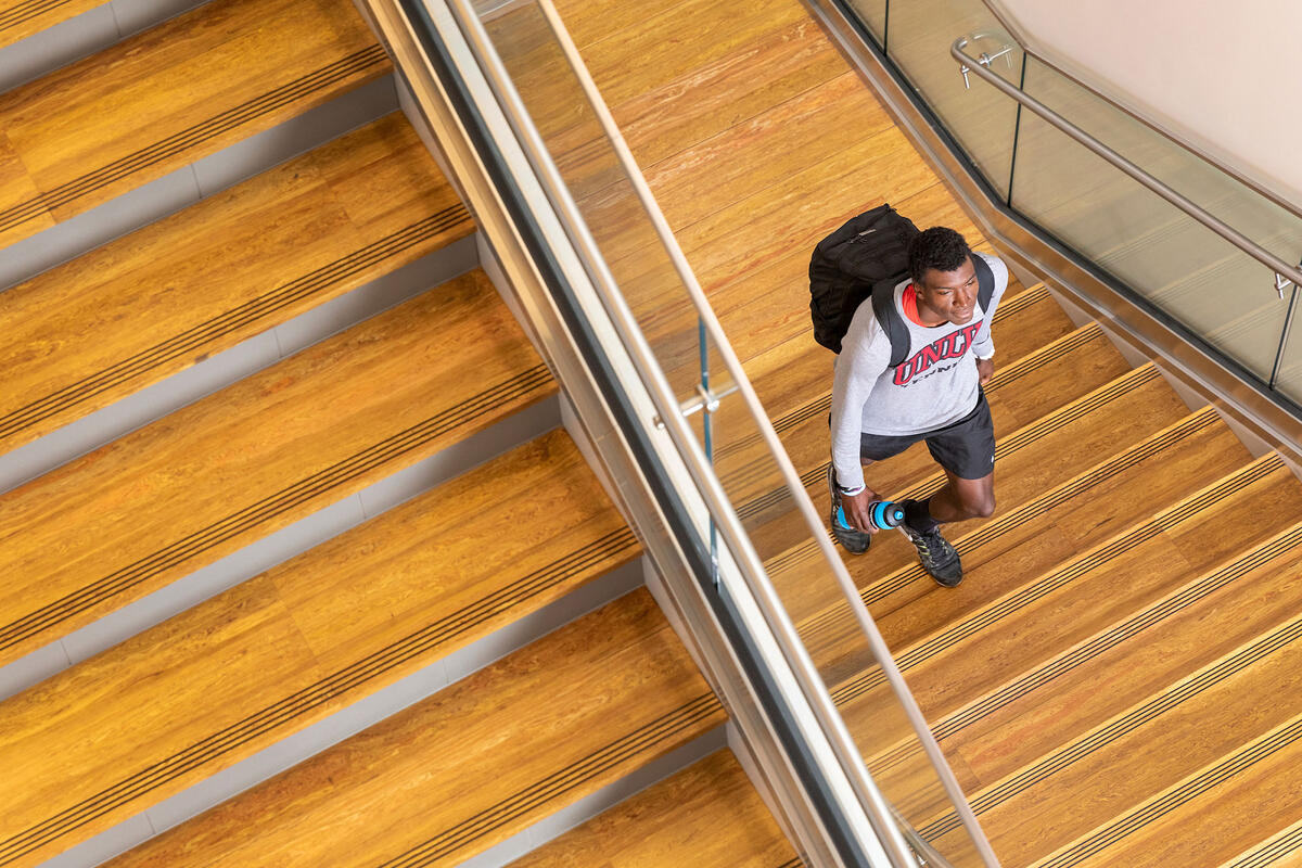 Male student walking down stairs