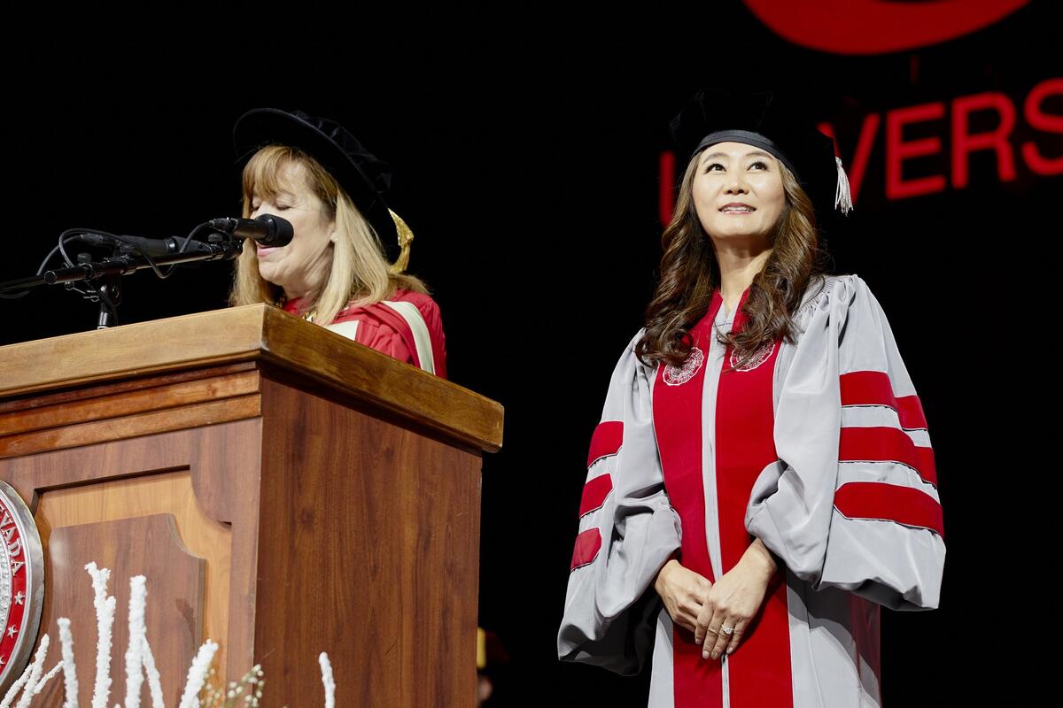 Woman standing near podium smiling
