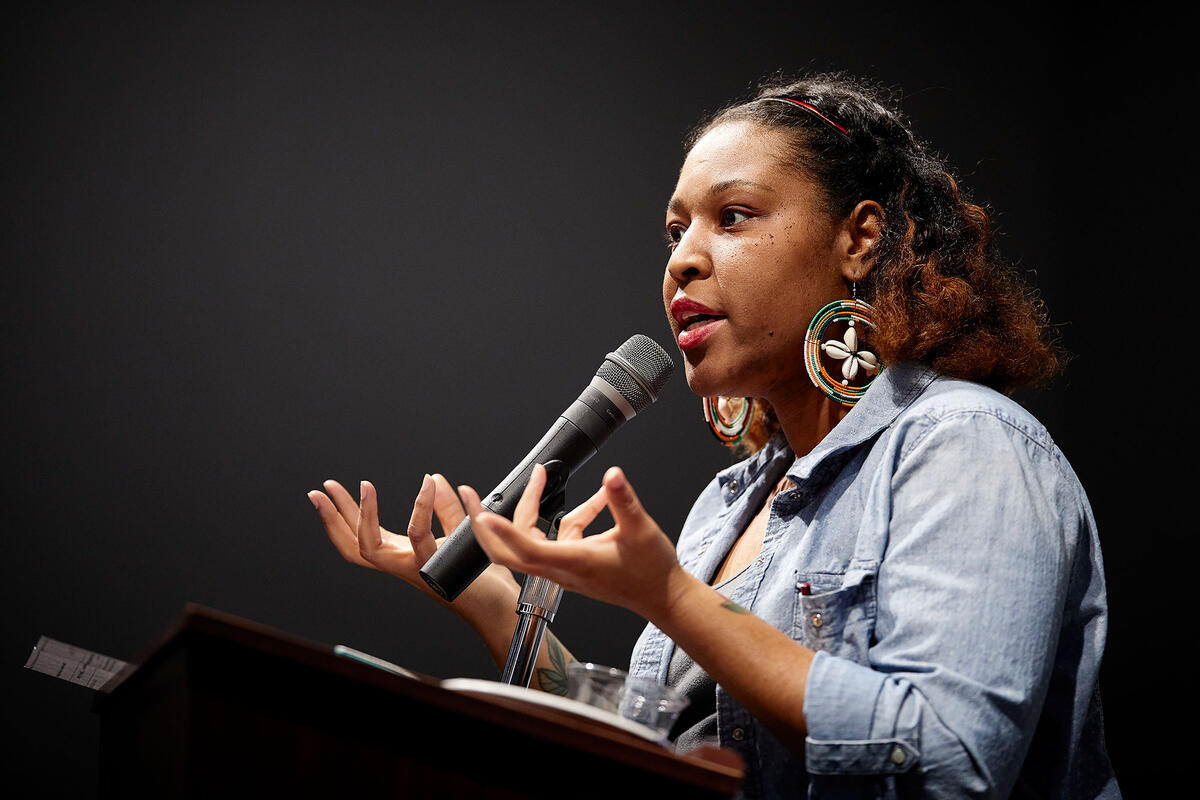 Black woman speaking into a microphone
