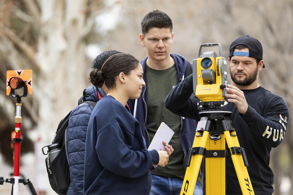 Group of people using a land survey