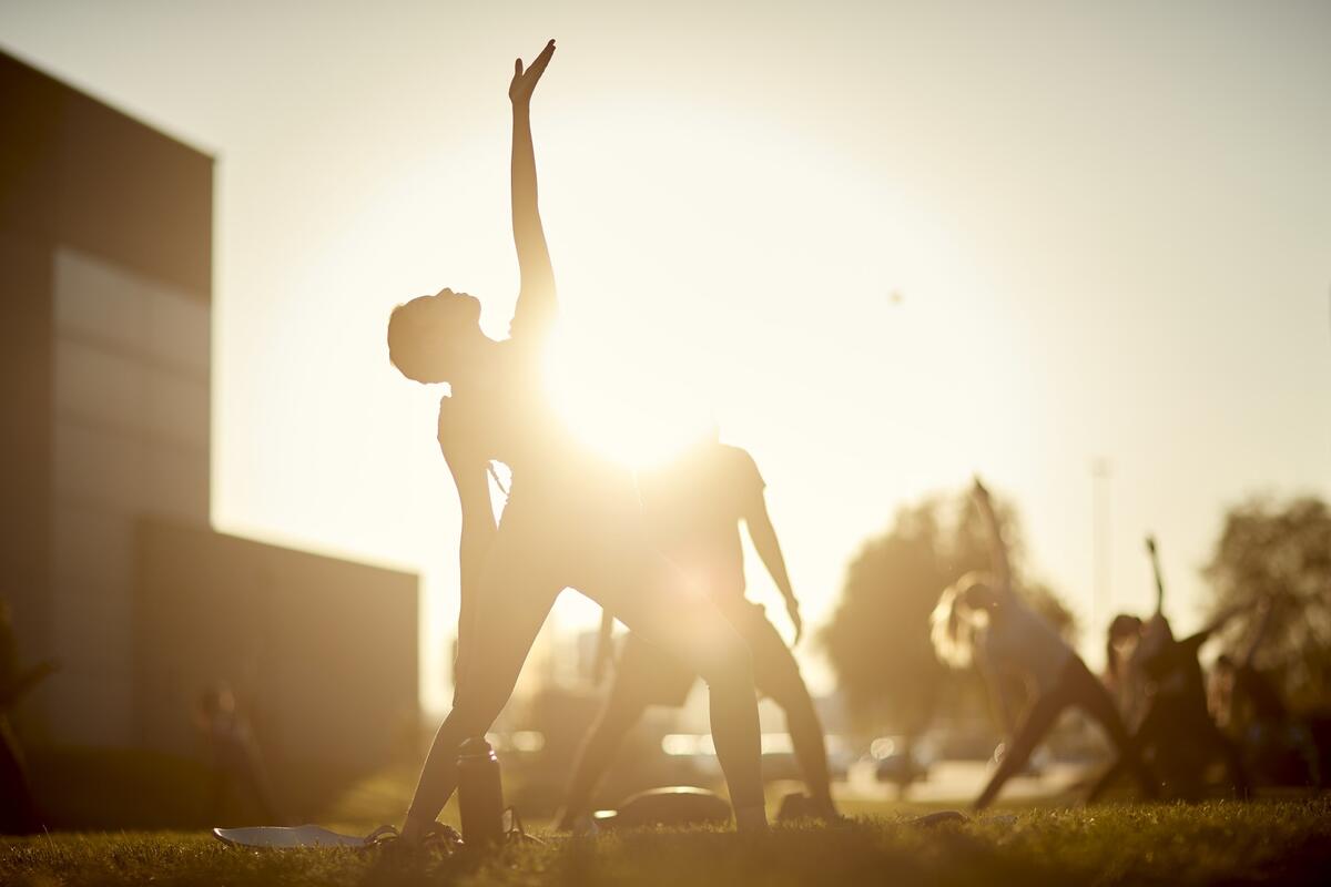 Women stretching in front of sunset