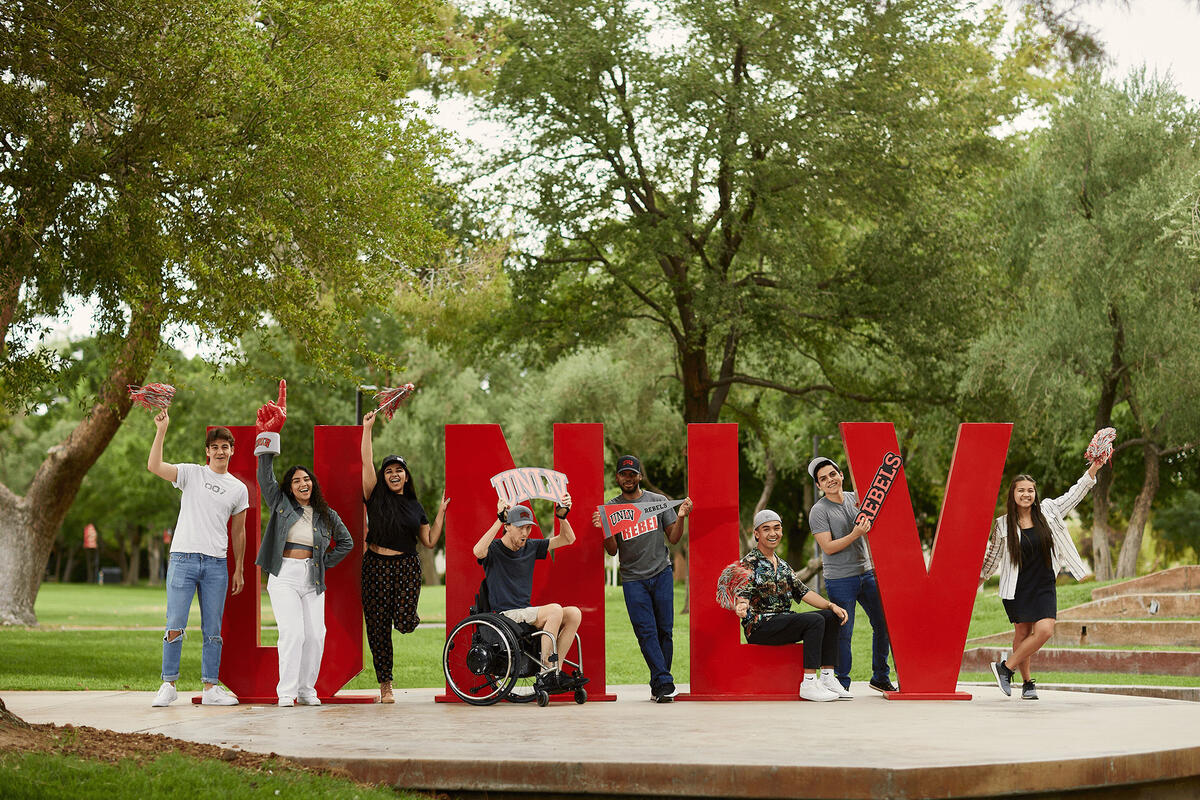 People posing in front of the UNLV sign.