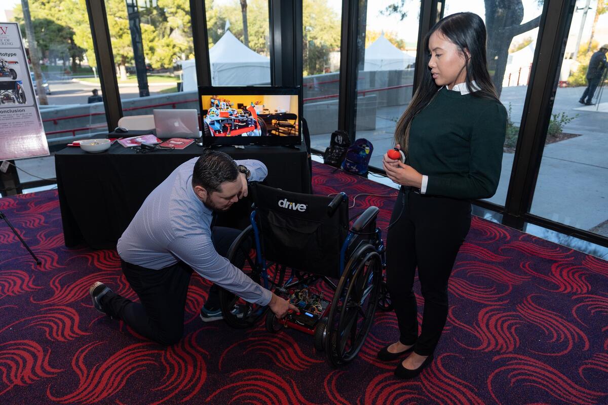 Woman standing in front of wheelchair