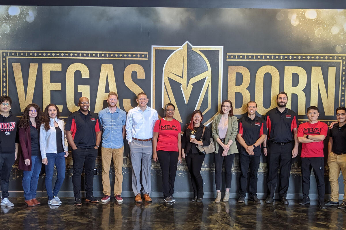 People standing in front of a "Vegas Born" Golden Knights sign