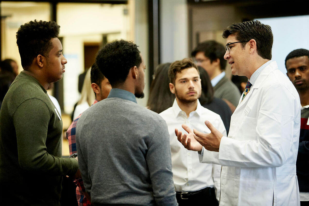 Students talking with Dr. Mario Gaspar de Alba, MD at the 1st Annual Pre-Medicine Conference on April 28, 2017