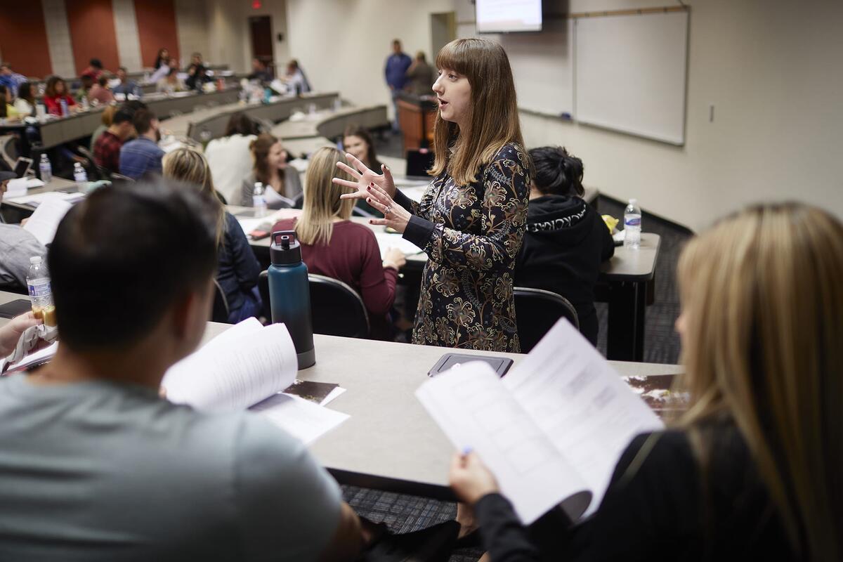 A student speaking in front of a class.